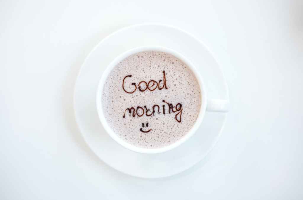 A cup of coffee with 'Good Morning' written on it.