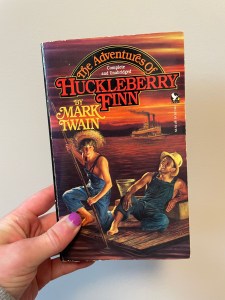 The Adventures of Huckleberry Finn by Mark Twain.