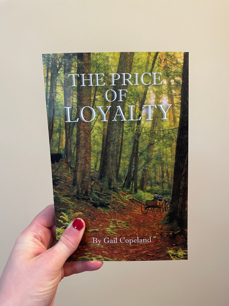 Someone holding a book up. The book cover says The Price of Loyalty by Gail Copeland and has images of a forest.